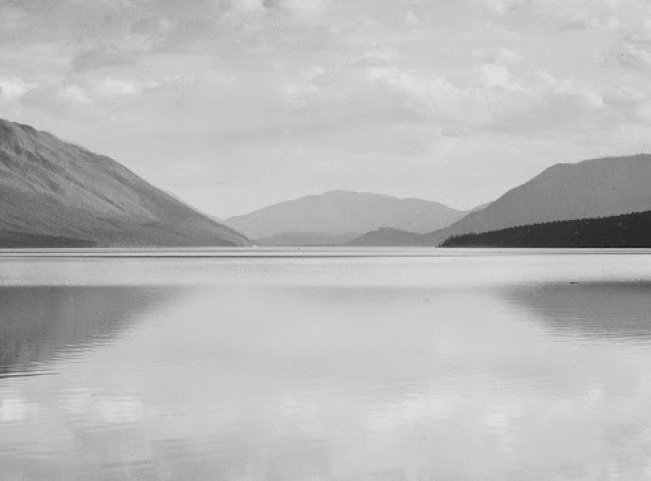 Looking_across_lake_toward_mountains,__Evening,_McDonald_Lake,_Glacier_National_Park,__Montana_,_1933_-_1942_-_NARA_-_519861